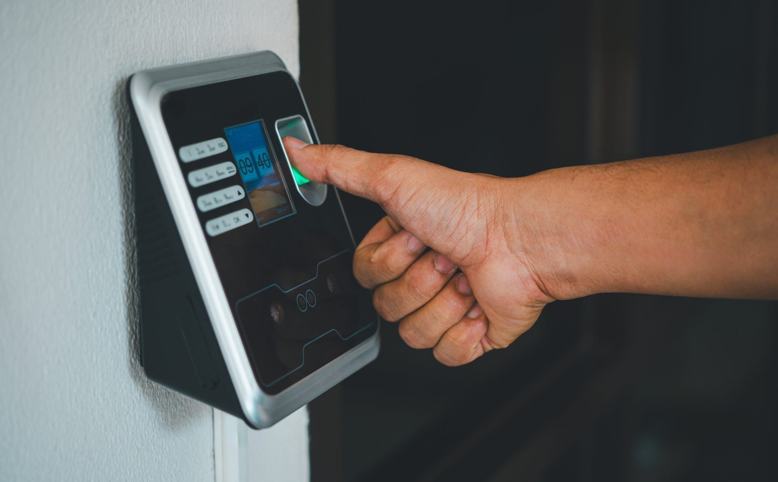A person is using a fingerprint reader to access a building | ITD Innovation Website in Dubai IT Services in UAE