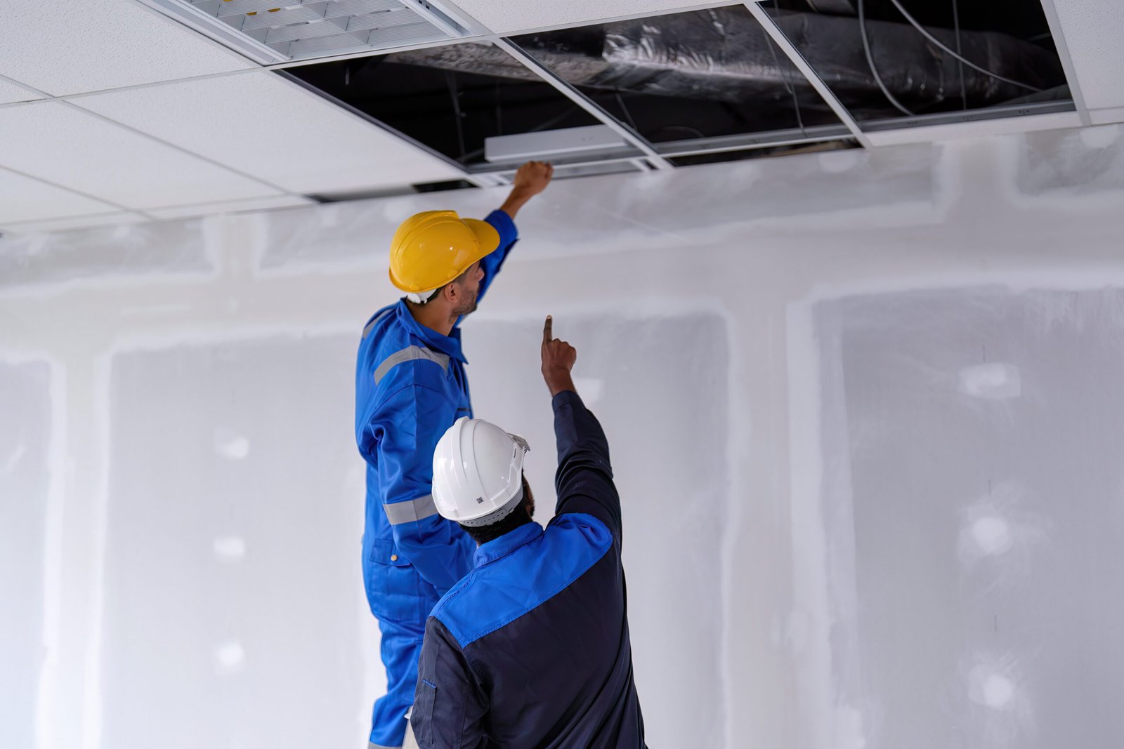 At new construction building worker open ceiling to check air condition duct on the top | ITD Innovation Website in Dubai Network Solutions in UAE